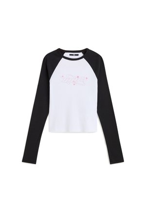 Long-sleeve raglan t-shirt with white body and black sleeves. Features a pink graphic design on the front. Made from soft cotton material.