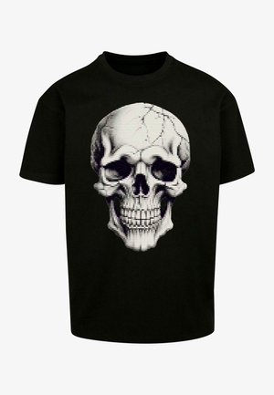 Čierne bavlnené tričko s detailným bielym grafickým motívom lebky s pixelovaným efektom a prasklinami na dizajne lebky.