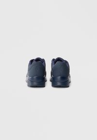 Navy blue athletic shoes with a textured upper, padded collar, and rubber sole. Features a logo on the heel and a streamlined design.
