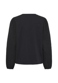 Haut noir à manches longues avec manches en dentelle texturée et poignets élastiques, dos uni, encolure ronde et coupe classique.