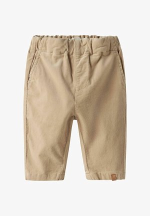 Pantalon en velours côtelé beige pour tout-petit avec taille élastique, poches latérales et une petite étiquette marron près de l'ourlet sur fond blanc.