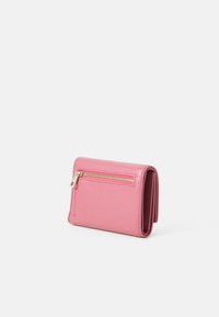 Pink faux leather wallet with a textured finish, featuring a zippered compartment and a compact design, stacked in a closed position.