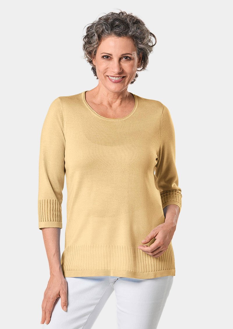 Gelber Strickpullover mit einem Rundhalsausschnitt und Dreiviertelärmeln, der ribbelige Akzente an den Bündchen und am Saum aufweist. Glatte Textur.