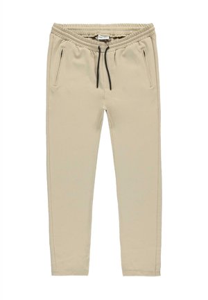 Beige joggerbroek gemaakt van zachte stof met een elastische tailleband, een trekkoord en twee zijzakken met zwarte accenten.