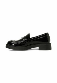 Black patent leather loafers with a low, chunky sole. Features a sleek design, rounded toe, and decorative strap across the vamp.