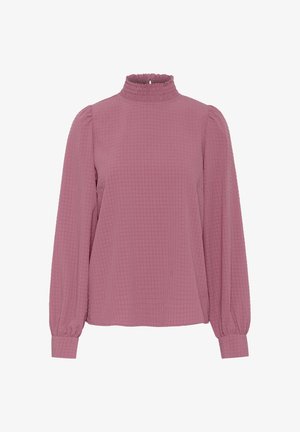 Dugi rukav, majica s teksturom waffles u blijedo ružičastoj boji s visokim, nabranim ovratnikom. Ima voluminozne rukave i elastične manžete za bolji kroj.
