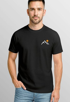 Black cotton t-shirt featuring white mountain graphics and an orange sun. Classic fit with short sleeves and a round neckline.
