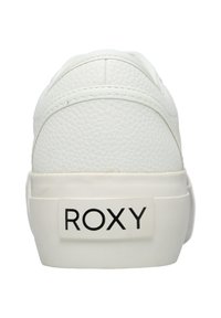 Back view of a white textured sneaker with thick sole and "ROXY" logo on the heel tab in black letters.