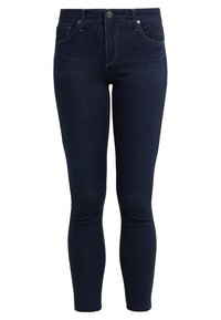 Mörk tvättade denim skinny jeans med hög midja, med framfickor, bältesöglor och fransad nederkant. Minimala sömdetaljer.