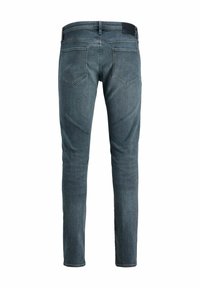 Slim fit jeans i mörkblå denim, med låg midja, subtila blekningsdetaljer och klassiska bakfickor med en strukturerad midjeband.