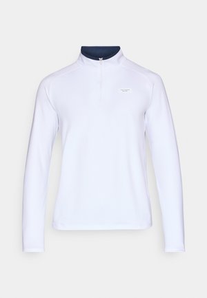 Hvit langermet genser med høy krage, glidelås foran og marineblå detaljer på kragen. Har en liten logo foran. Glatt tekstur.