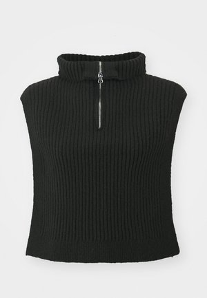 Schwarzer gerippter Pullover mit hohem Kragen und kurzen Ärmeln, ausgestattet mit einem Frontreißverschluss. Das Material wirkt weich mit einer strukturierten Oberfläche.