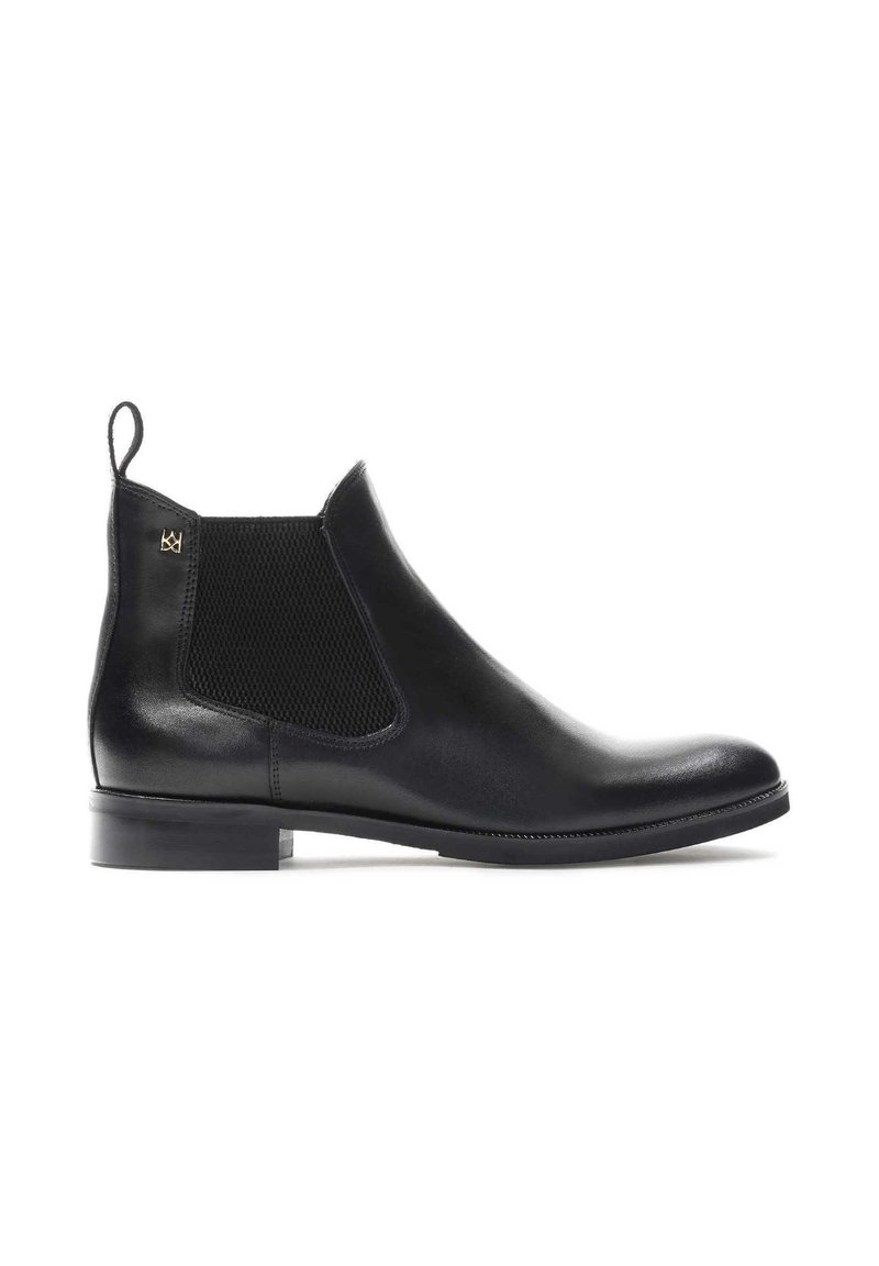 Black leather Chelsea boot with elastic side panels, rounded toe, and a low block heel. Features a pull tab for easy wear.