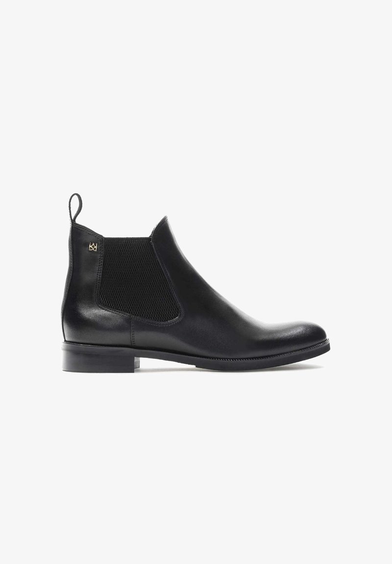 Black leather Chelsea boot with elastic side panels, rounded toe, and a low block heel. Features a pull tab for easy wear.