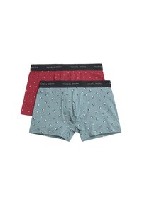 Dos pares de boxer para hombre, uno marrón con pequeños puntos blancos y otro azul claro con pequeños estampados de perros en negro y blanco, ambos con cinturillas negras etiquetadas "YSABEL MORA".