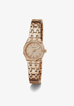 Rose gold watch with an octagonal face, studded with rhinestones, a textured dial, and a link bracelet design. Brand: Guess.