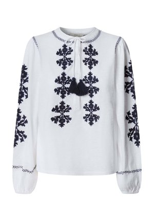 Witte blouse met lange mouwen en zwart ingewikkeld bloemenborduurwerk aan de voorkant en mouwen, voorzien van een ronde hals met strik en kwastjes.