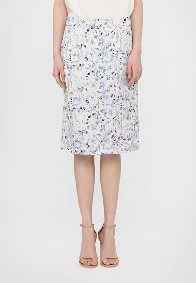 Floral pencil skirt in white, adorned with blue and navy leaf patterns. Knee-length, smooth fabric with a fitted silhouette.