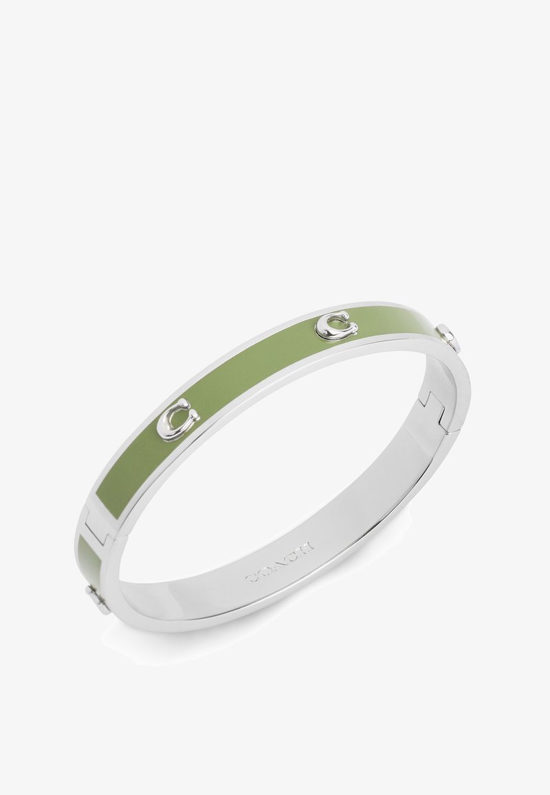 Silver bangle bracelet featuring a rectangular green enamel inlay, accented with two small logo details and a sleek clasp design.
