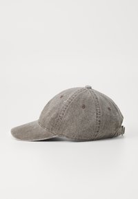 Gray fabric baseball cap with a curved visor, soft texture, six-panel design, and adjustable strap at the back. Features brown stitching accents.