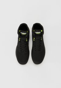 Black athletic shoes with a mesh upper, textured surface, neon green accents, lace-up design, and padded ankle collar.