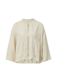 Lichtbeige ritsjack met een ronde hals, verlaagde schouders, twee voorkzakken en een trekkoord aan de onderkant voor een verstelbare pasvorm.