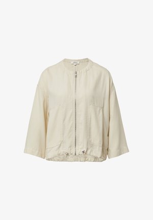 Veste zippée beige clair avec un col rond, des épaules tombantes, deux poches avant et un cordon de serrage à l'ourlet pour un ajustement personnalisé.