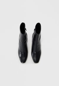 Black leather ankle boots with a pointed toe and side zipper, featuring a smooth texture and a sleek silhouette.