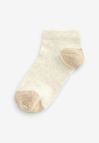 Chaussettes montantes beige clair avec un talon et un bout de couleur beige foncé contrastants. Texture côtelée avec une finition douce et lisse.