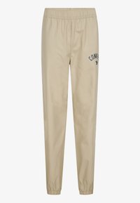 Beige joggerbyxor med elastisk midja, som har en liten marinblå "Converse"-logotyp och stjärna. Slät, lätt tyg, avsmalnande mudd.