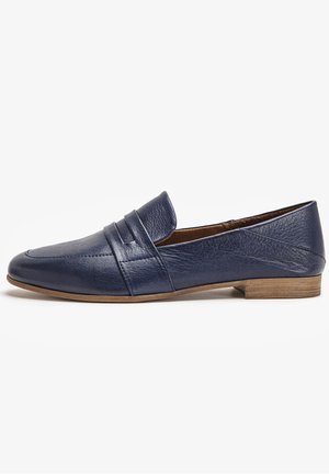 Mocasín de cuero azul marino con tacón bajo de madera, puntera redondeada, tira decorativa sobre la pala y acabado liso.