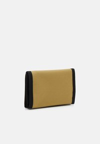 Folded wallet made of textured mustard fabric with black edges. Compact rectangular shape, suitable for carrying cards and cash.