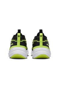 Black and neon green athletic shoes feature a breathable mesh upper, padded collar, and a thick white sole with textured detailing.