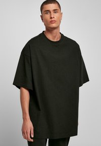 Verkeerd zwarte katoenen t-shirt met een ronde hals, korte mouwen en een zachte textuur, ontworpen voor een losse pasvorm en casual dragen.