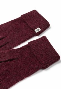 Pair of maroon knitted wool gloves with a small white fabric tag on the cuff, displayed on a white background.