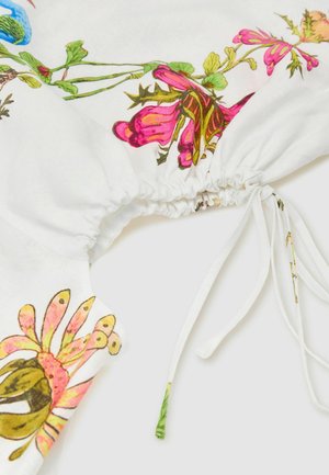 Hvidt stof med pink og grønne blomsterprint, med indsamlet elastikdetalje og justerbart bindeslukning.