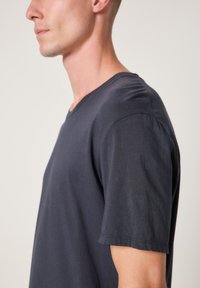 Navy blue short-sleeve t-shirt with a V-neck design, made of a smooth cotton blend fabric, featuring a relaxed fit and subtle texture.