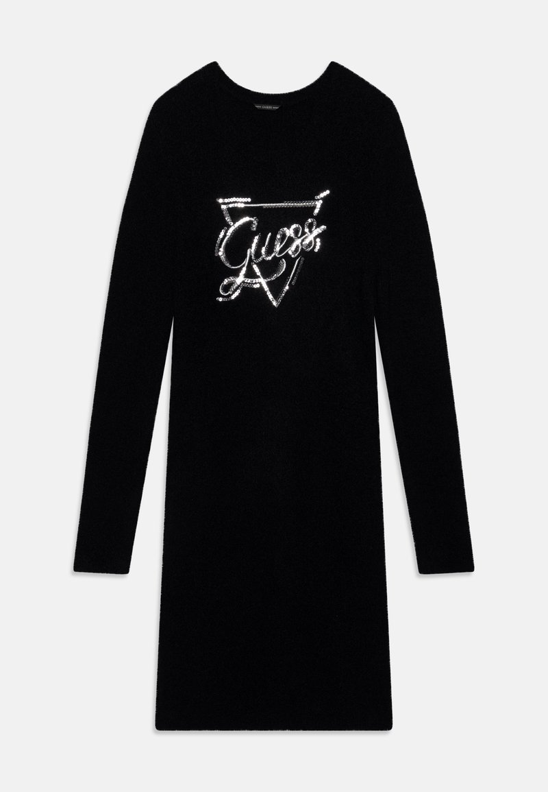 Robe noire ajustée à manches longues avec un col rond, ornée d'un logo "Guess" en sequins argentés dans un triangle sur la poitrine.