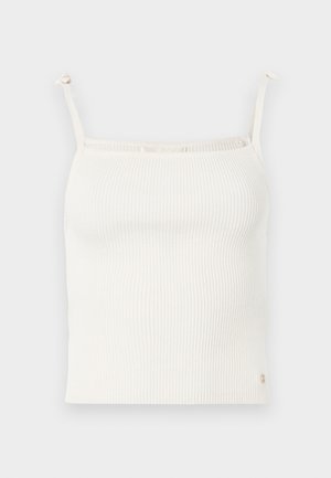Rýhovaná, krémová tílko s tenkými, nastavitelnými ramínky a malým logem na lemu. Měkká textura. Přiléhavý design.