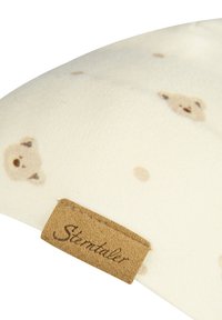 Soft fabric cushion featuring a cream background with light brown bear patterns. Includes a tan label with "Sterntaler" in brown text.