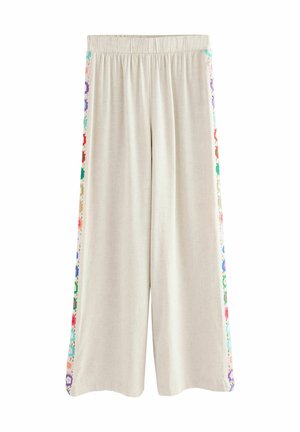 Pantaloni culotte beige con cintura elastica, impreziositi da un ricamo floreale colorato lungo le cuciture laterali e realizzati in un tessuto morbido e strutturato.