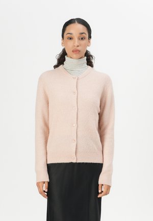 Light pink cardigan made of soft knit material. Features a round neckline, five buttons, ribbed cuffs, and hem. Worn over a striped turtleneck.