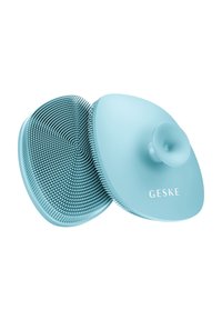 Blauwe siliconen hoofdhuid masseerder met ronde randen, gestructureerde borstels en een centraal handvat. Bevat merknaam "GESKE" op het oppervlak.