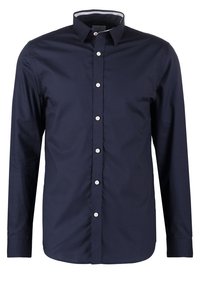 Tmavě modrá košile s dlouhým rukávem na knoflíky, vyrobená z hladké látky, s klasickým límcem, bílými knoflíky a vzorovanou podšívkou uvnitř límce.