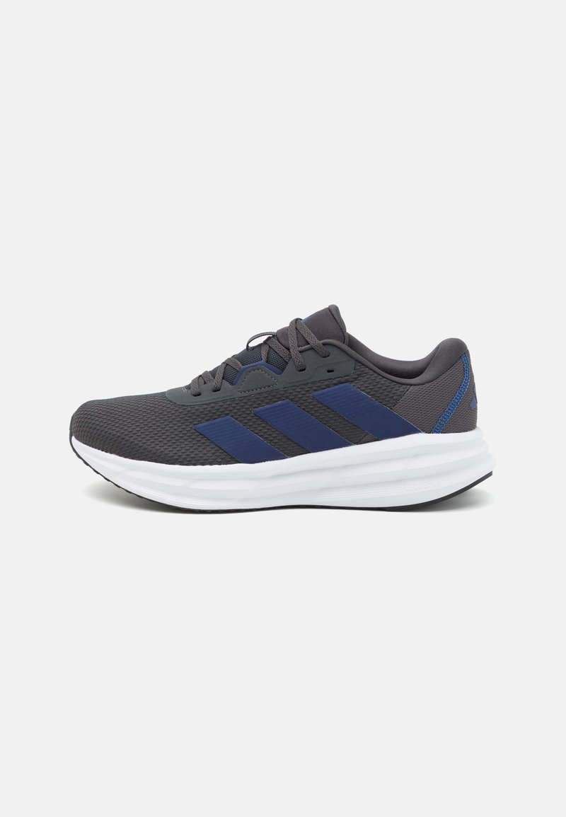 Men's running shoe, grey mesh upper with blue accents, textured finish, white cushioned midsole, black rubber outsole, classic three-stripe design.