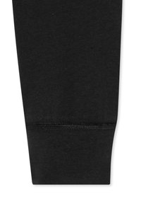 Black cotton leggings featuring a smooth texture, tapered design, and elastic waistband with stitched detailing at the hem.