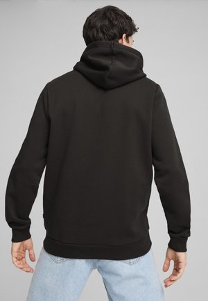 Felpa nera con cappuccio realizzata in tessuto morbido, con tasca a marsupio, polsini a costine e orlo dritto. Design semplice e minimalista.