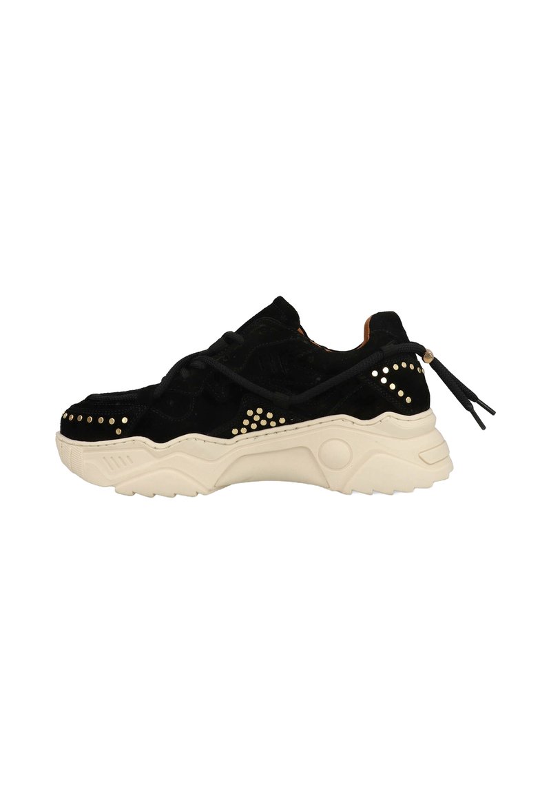 Black suede sneaker with beige sole, featuring decorative studs, laces, and a pull tab at the heel, showcasing a chunky design.