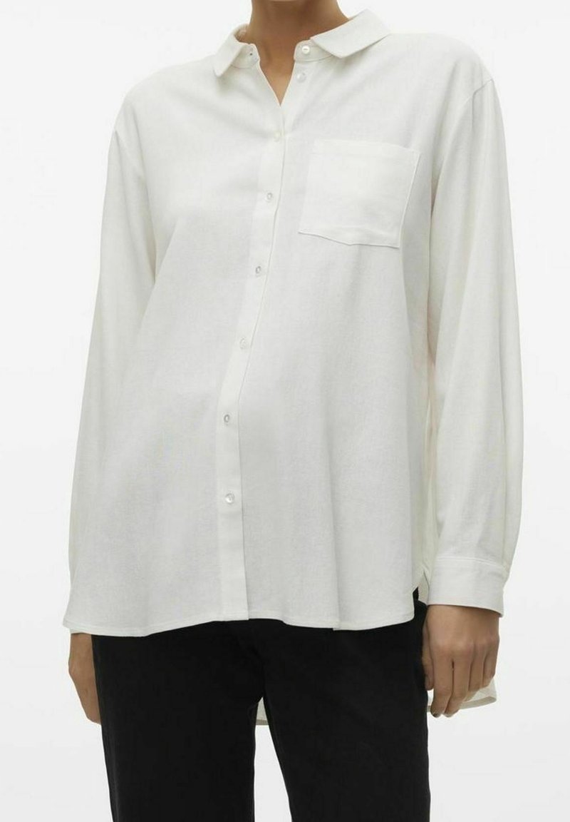 Valkoinen napillinen kauluspaita, jossa on kaulus ja yksi rintatasku. Valmistettu kevyestä, hengittävästä kankaasta, jossa pitkät hihat ja rento istuvuus.