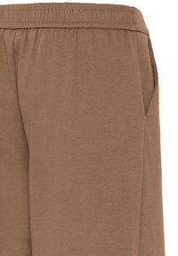 Pantalon marron avec ceinture élastique et poche latérale, fabriqué en tissu doux.
